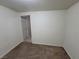 Neutral bedroom featuring blank walls, carpet floors, and a door to the hallway at 1929 Evelyn Ave, Henderson, NV 89011