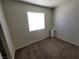 Neutral carpeted bedroom with window and portable air conditioner at 1929 Evelyn Ave, Henderson, NV 89011