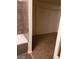 Walk-in closet with storage and a bathroom with tiled walls and a tub at 1929 Evelyn Ave, Henderson, NV 89011