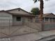 Single-story home with metal gated courtyard and covered entry, offering privacy and a secure outdoor space at 1929 Evelyn Ave, Henderson, NV 89011