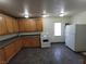 Functional kitchen equipped with wood cabinets and white appliances at 1929 Evelyn Ave, Henderson, NV 89011