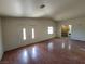 Open living room with hardwood floors, bright double door entry, and a view to the kitchen, ideal for entertaining at 1929 Evelyn Ave, Henderson, NV 89011