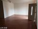 Inviting living room featuring laminate floors, a well-lit entry door, and a spacious layout for comfortable living at 1929 Evelyn Ave, Henderson, NV 89011
