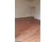Bright room with wood-look flooring and white door at 1929 Evelyn Ave, Henderson, NV 89011
