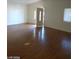 Spacious living room featuring light walls, wood flooring, and natural light through the window at 1929 Evelyn Ave, Henderson, NV 89011