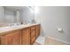 Double vanity bathroom with wood cabinets and tile flooring at 50 E Serene Ave # 107, Las Vegas, NV 89123