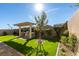 Landscaped backyard with a pergola, built-in grill, and artificial turf at 10137 Skye Saddle Ave, Las Vegas, NV 89166