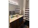 Functional bathroom features a double vanity, a large mirror, and a shower with a striped curtain at 2305 W Horizon Ridge Pkwy # 3512, Henderson, NV 89052