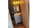 Bathroom with grey vanity, mirror, and modern light fixture at 3909 Woodhill Ave, Las Vegas, NV 89121