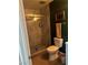 Bathroom with a glass-enclosed shower, modern fixtures, and elegant marble-look tile at 3909 Woodhill Ave, Las Vegas, NV 89121