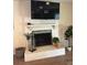 Cozy fireplace with white brick surround, mantle, and decorative accessories at 3909 Woodhill Ave, Las Vegas, NV 89121