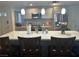 Bright kitchen featuring an island with quartz countertops and modern pendant lighting at 3909 Woodhill Ave, Las Vegas, NV 89121