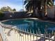 Beautiful backyard pool surrounded by lush palm trees and mature landscaping at 3909 Woodhill Ave, Las Vegas, NV 89121