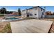 Large backyard with patio slab, pool, and two-story home at 6315 N El Capitan Way, Las Vegas, NV 89149