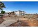 Two-story home with backyard, desert landscaping, and privacy fence at 6315 N El Capitan Way, Las Vegas, NV 89149