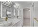 Modern bathroom featuring double sinks, sleek white marble, and gold fixtures at 6315 N El Capitan Way, Las Vegas, NV 89149