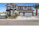 Two-story stucco home with a two car garage, palm trees and stone accents at 6315 N El Capitan Way, Las Vegas, NV 89149
