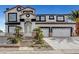 Two-story stucco home with a two car garage and lush landscaping at 6315 N El Capitan Way, Las Vegas, NV 89149