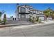 A two-story stucco home with palm trees and desert landscaping at 6315 N El Capitan Way, Las Vegas, NV 89149