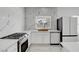 Modern kitchen with marble counters, stainless steel appliances, and ample counter space at 6315 N El Capitan Way, Las Vegas, NV 89149