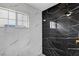This bathroom features a black marble shower with brass fixtures and a window at 6315 N El Capitan Way, Las Vegas, NV 89149