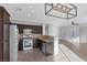 Modern kitchen with dark brown cabinets and stainless steel appliances at 135 Gracious Crest Ave, North Las Vegas, NV 89032