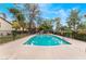Inviting community pool surrounded by a fence and lush greenery at 3125 Pinehurst Dr # A, Las Vegas, NV 89109