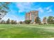 Beautiful expansive grass lawn leading up to a modern high-rise building with blue skies at 3125 Pinehurst Dr # A, Las Vegas, NV 89109