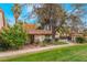 A well-maintained single-story home featuring mature trees, lush landscaping, and a sidewalk at 3125 Pinehurst Dr # A, Las Vegas, NV 89109