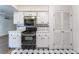 Charming kitchen features white cabinets, tiled countertops, and black appliances at 3125 Pinehurst Dr # A, Las Vegas, NV 89109
