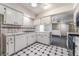 Bright kitchen showcasing white cabinetry, contrasting black appliances and tiled countertops at 3125 Pinehurst Dr # A, Las Vegas, NV 89109