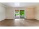 Open living room features tile floors and sliding door to patio at 3125 Pinehurst Dr # A, Las Vegas, NV 89109