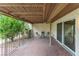 An outdoor brick patio with a covered ceiling, sliding glass door, and a beautiful leafy lemon tree at 3125 Pinehurst Dr # A, Las Vegas, NV 89109