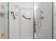 A bathroom shower featuring safety handles and white surfaces at 3125 Pinehurst Dr # A, Las Vegas, NV 89109