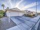 Two-car garage and well-manicured front yard at 6209 Peggotty Ave, Las Vegas, NV 89130