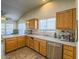 Modern kitchen with wood cabinets and a large window at 6209 Peggotty Ave, Las Vegas, NV 89130