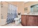 Cozy bathroom featuring a tub with a patterned shower curtain and neutral color scheme at 6868 Sky Pointe Dr # 2039, Las Vegas, NV 89131