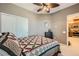 Bedroom with a ceiling fan, double sliding door closet and view into connected kitchen at 6868 Sky Pointe Dr # 2039, Las Vegas, NV 89131
