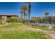 Beautiful community pool area with green grass, lush landscaping, and nearby residential buildings on a sunny day at 6868 Sky Pointe Dr # 2039, Las Vegas, NV 89131
