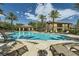 Relaxing community pool with lounge chairs, palm trees, and a covered area for residents to enjoy at 6868 Sky Pointe Dr # 2039, Las Vegas, NV 89131