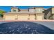 Low angle of building exterior with multi-car garage doors and desert landscaping at 6868 Sky Pointe Dr # 2039, Las Vegas, NV 89131