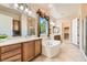 Elegant bathroom with double sinks, soaking tub, and walk-in shower at 2112 Silent Echoes Dr, Henderson, NV 89044