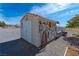 White storage shed with tools and gardening equipment at 3581 Pahrump Valley Blvd, Pahrump, NV 89048