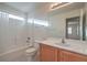 Bright bathroom featuring wood cabinets and a bathtub shower combo at 9844 Ashton Pines Ct, Las Vegas, NV 89147