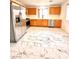 The kitchen features stainless steel appliances, marble tile, and wood cabinets at 9844 Ashton Pines Ct, Las Vegas, NV 89147