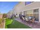 Backyard featuring an outdoor dining set, artificial grass, a trampoline and pavers at 10172 Magnolia Creek St, Las Vegas, NV 89141