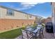 Backyard featuring an outdoor dining set, artificial grass, a trampoline and pavers at 10172 Magnolia Creek St, Las Vegas, NV 89141