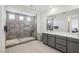 Modern bathroom featuring a sleek, frameless glass shower with stylish gray tile at 10172 Magnolia Creek St, Las Vegas, NV 89141