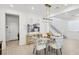 Dining room features a modern chandelier and views of the entryway and staircase at 10172 Magnolia Creek St, Las Vegas, NV 89141