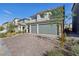 Two-story home with a three-car garage and a brick driveway at 10172 Magnolia Creek St, Las Vegas, NV 89141